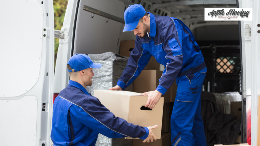 movers putting box inside moving van